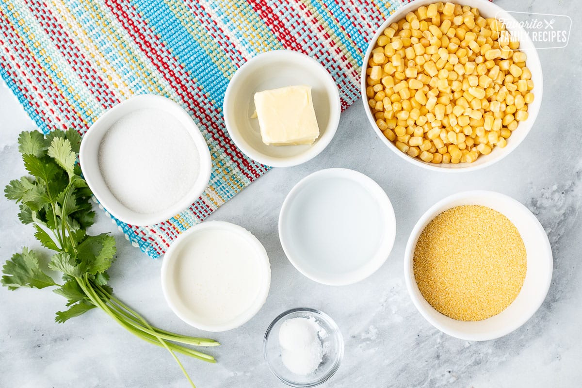 Ingredients to make Sweet Corn Cakes (Tomalitos) including frozen corn, butter, corn meal, water, baking powder, salt, sugar and cream.