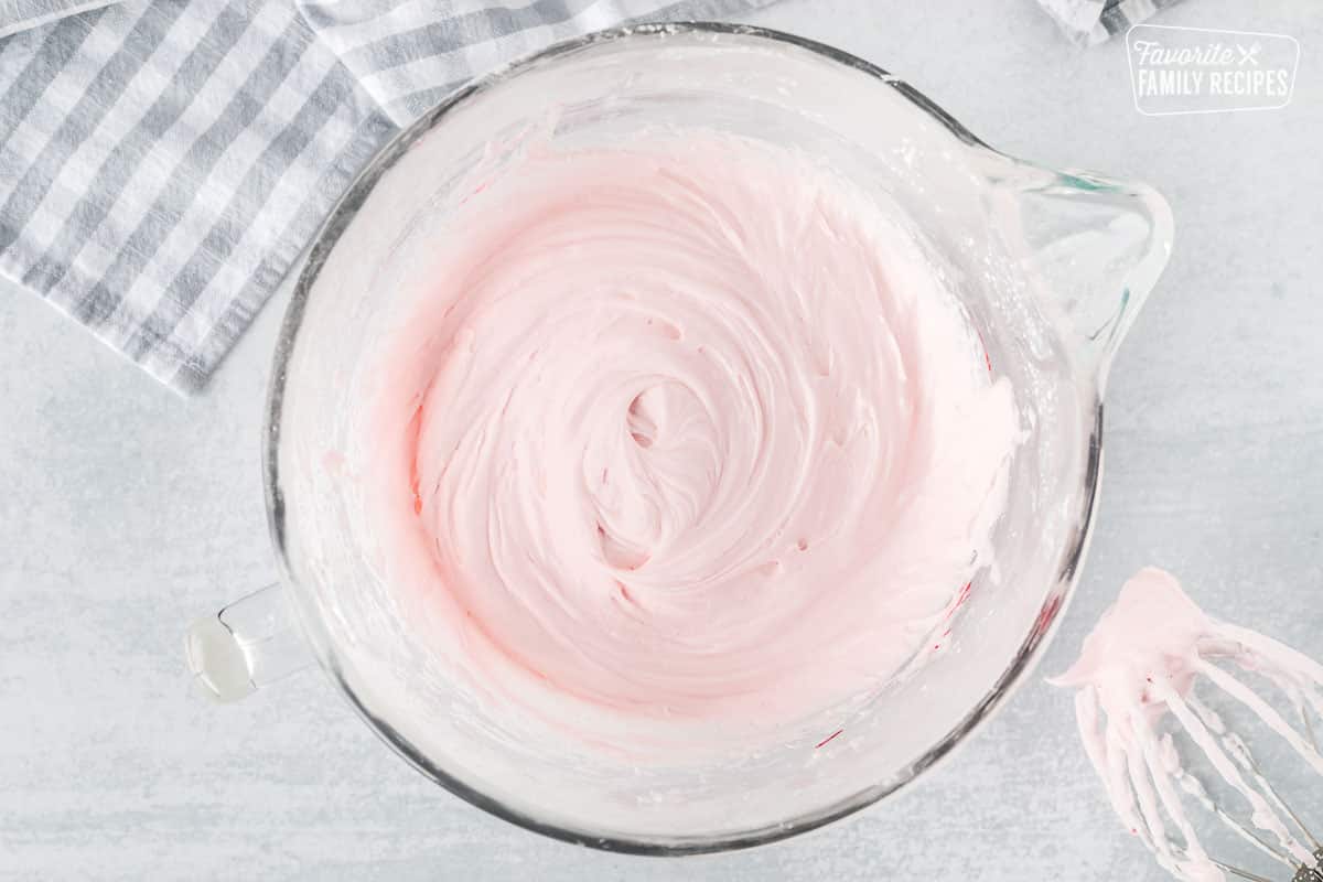 Mixing bowl with pink frosting for Swig Cookies.