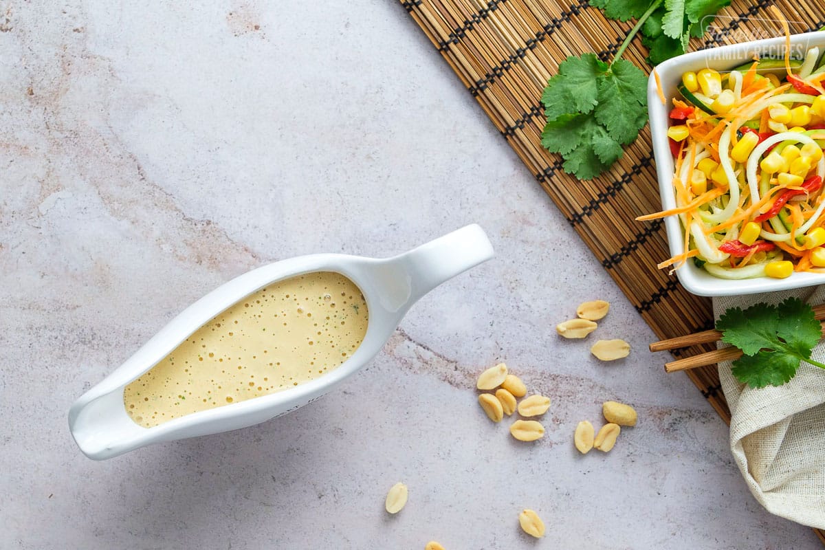 overhead view of Thai peanut dressing in a pouring container