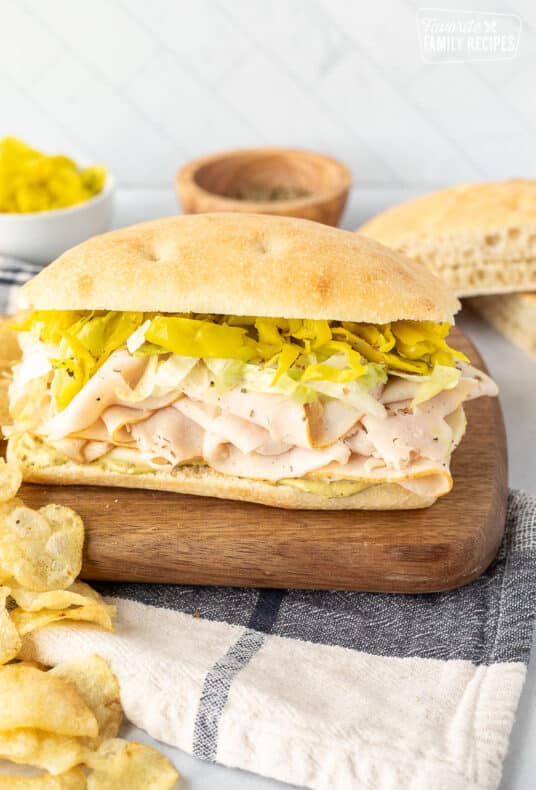 Turkey Over Italy sandwich with chips.