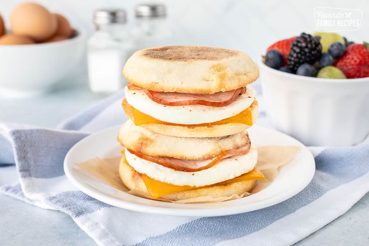 Two Egg McMuffins with Canadian bacon, egg and cheese stacked on top of each other.