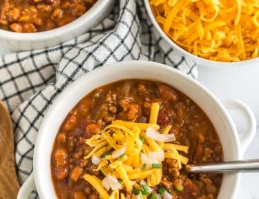 Wendy's Chili in a bowl topped with cheese, onions, and chives