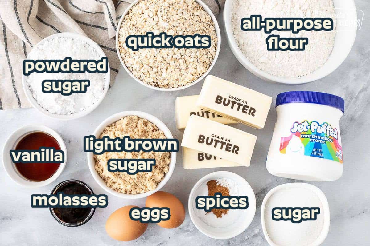 Ingredients to make Oatmeal Cream Pies including flour, oatmeal, powdered sugar, sugar, brown sugar, vanilla, molasses, eggs, butter, spices and marshmallow fluff.