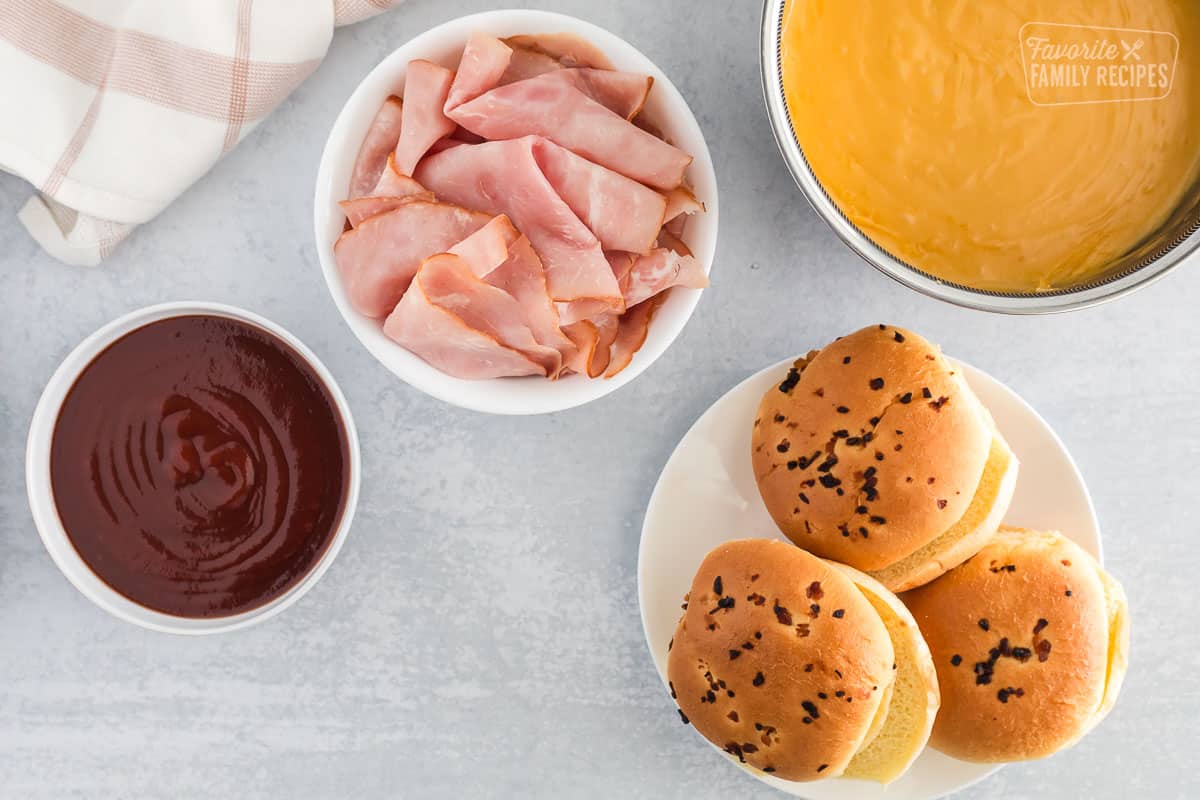 Ingredients for an Arby's Ham and Cheddar Melt including ham, Arby's sauce, onion buns, and Cheddar Cheese sauce