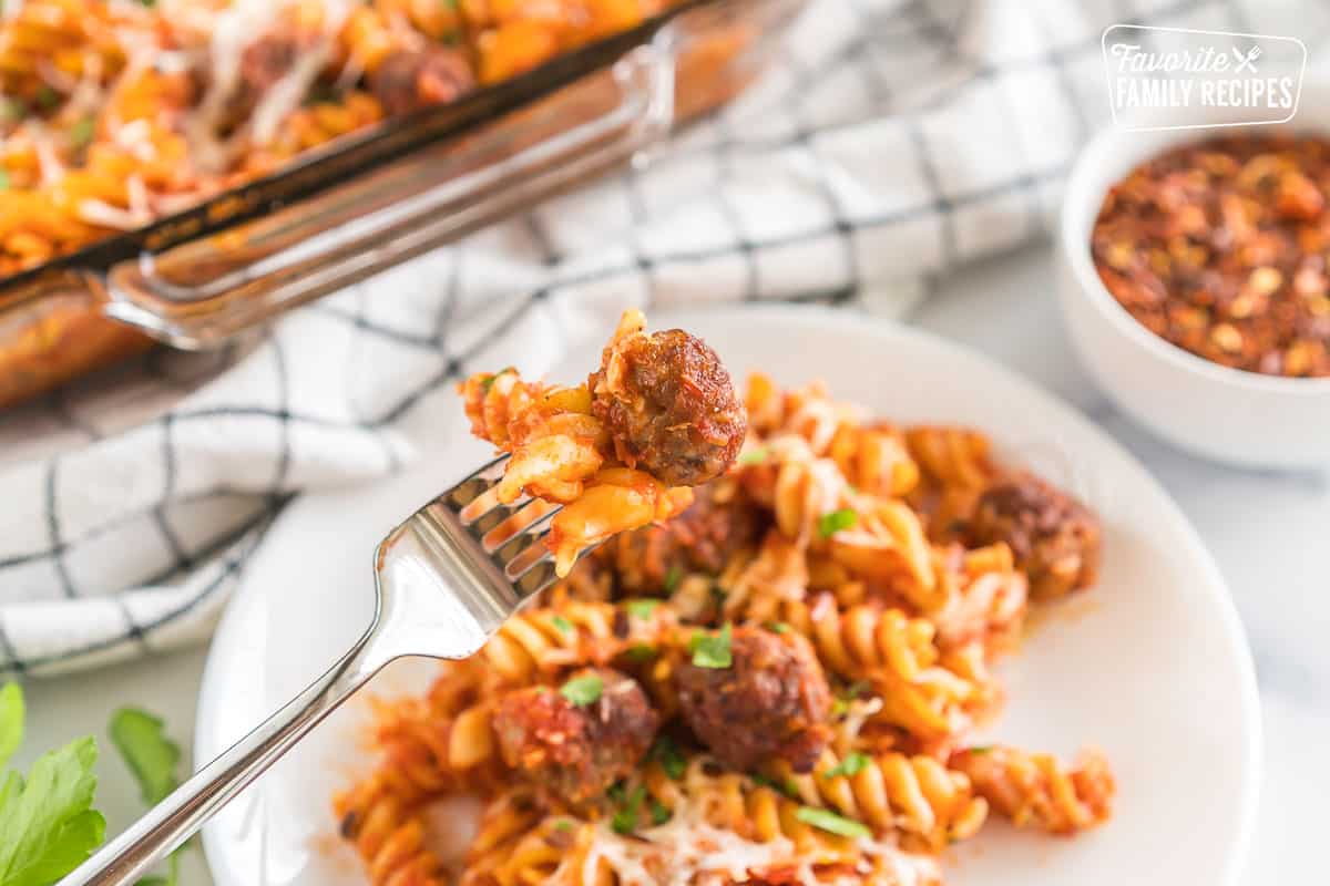A fork with pasta and meatballs