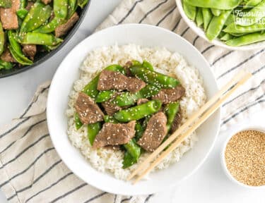 a bowl of beef and snow peas
