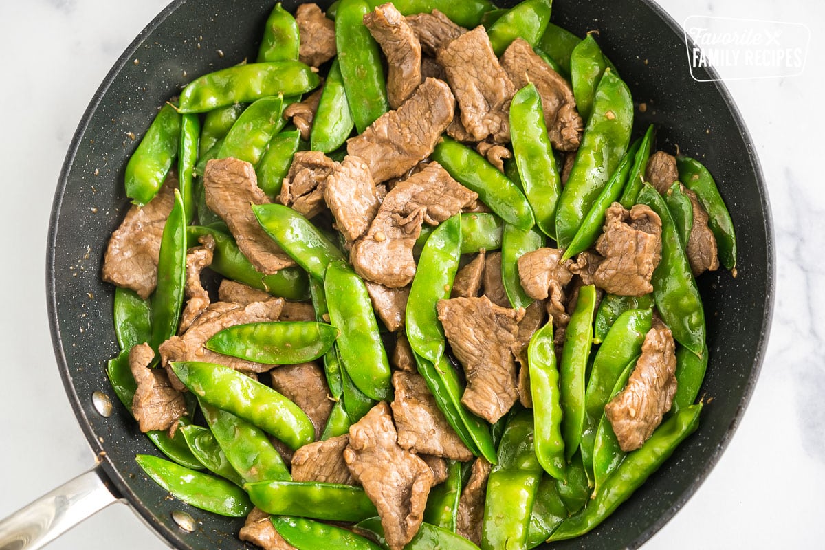 meat and veggies cooking in a skillet