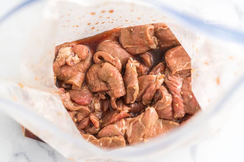 thinly sliced beef marinating in a ziplock bag