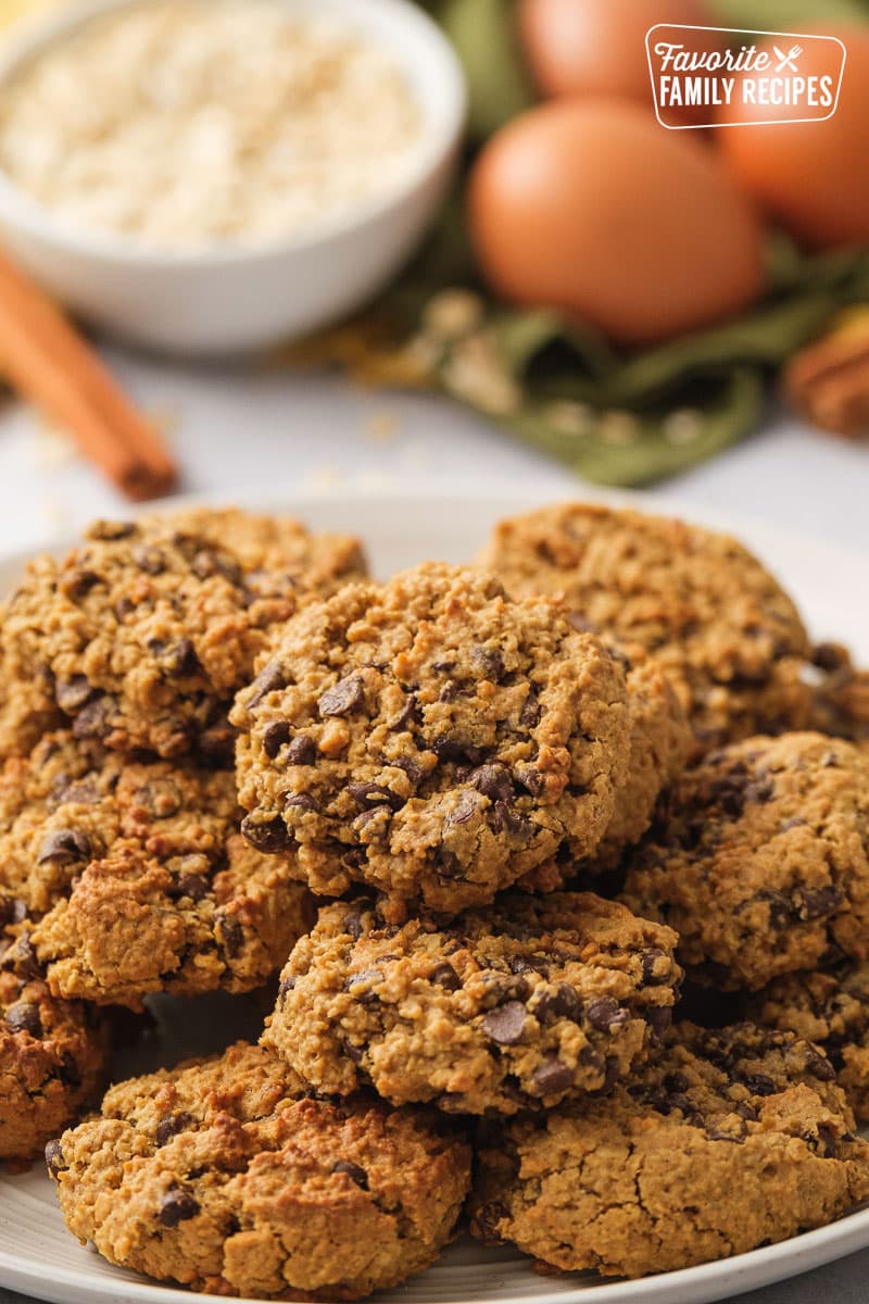 A stack of oatmeal chocolate chip cookies on a white plate. 