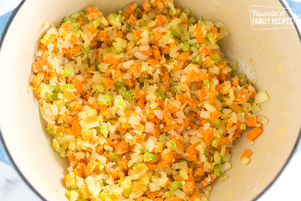 carrots, celery, and onion in a pot coated with flour
