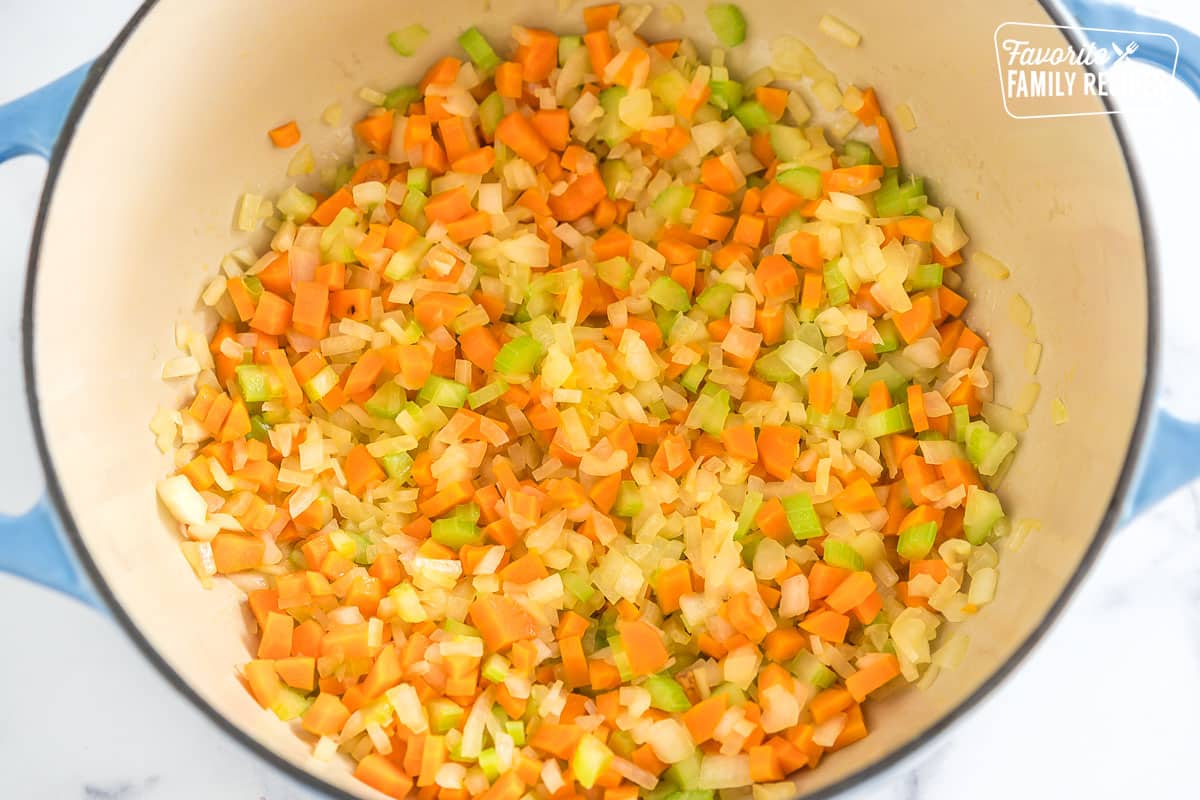 carrots, celery, and onion sautéing in a pan