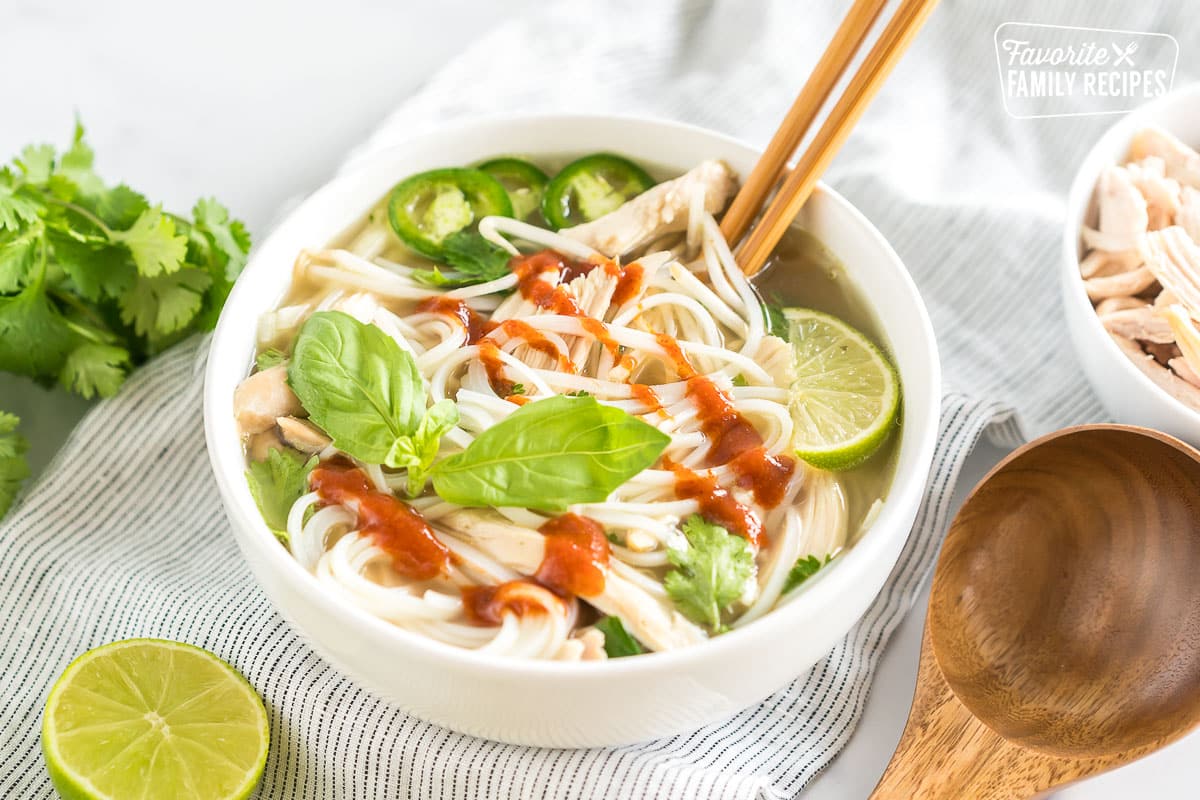 A bowl of Chicken Pho topped with sriracha
