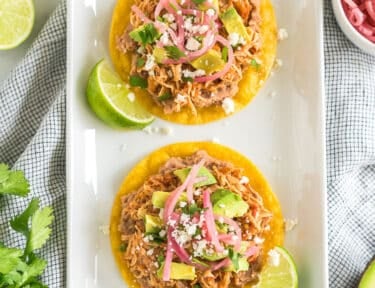 Two chicken tostadas on a platter