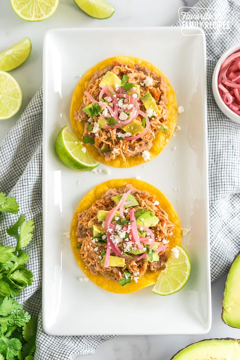 Two chicken tostadas on a platter