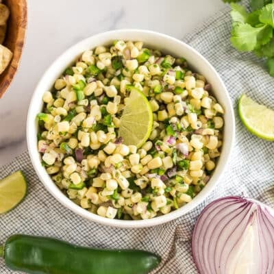 A bowl of Chipotle Corn Salsa topped with a lime wedge