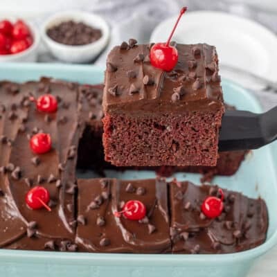 Spatula lifting a slice of Chocolate Cherry Cake.