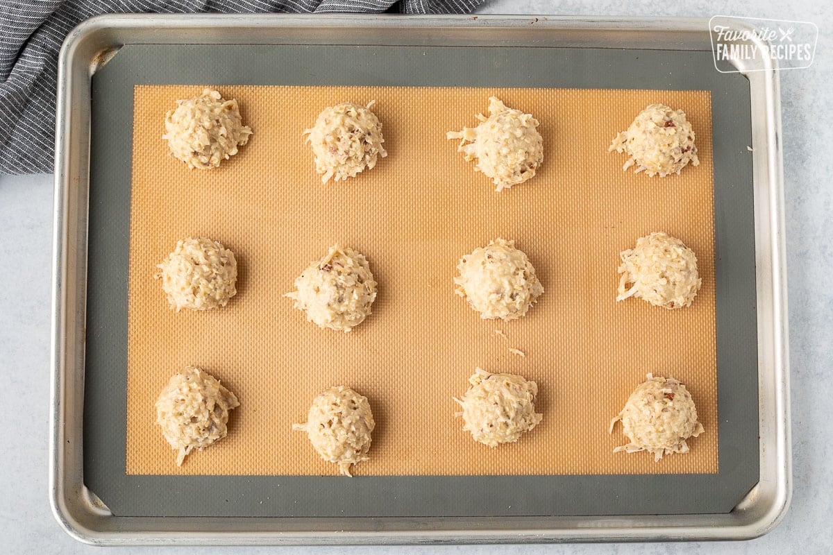 Cookie sheet with balls of coconut banana cookie dough.