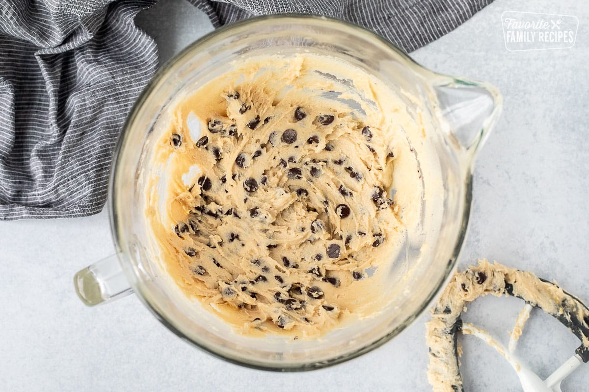 Mixing bowl with chocolate chip cookie dough. Mixing paddle on the side.