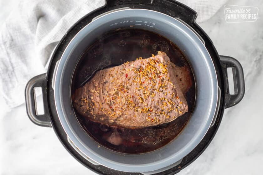 Instant Pot with cooked Corned Beef.