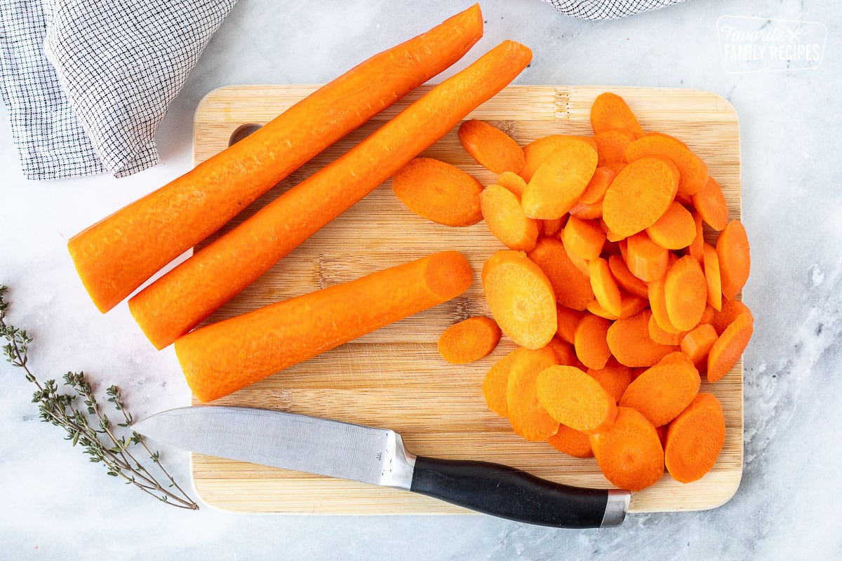 Cutting board with cut carrots.