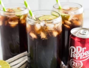 Dirty Dr Pepper with lime and a straw