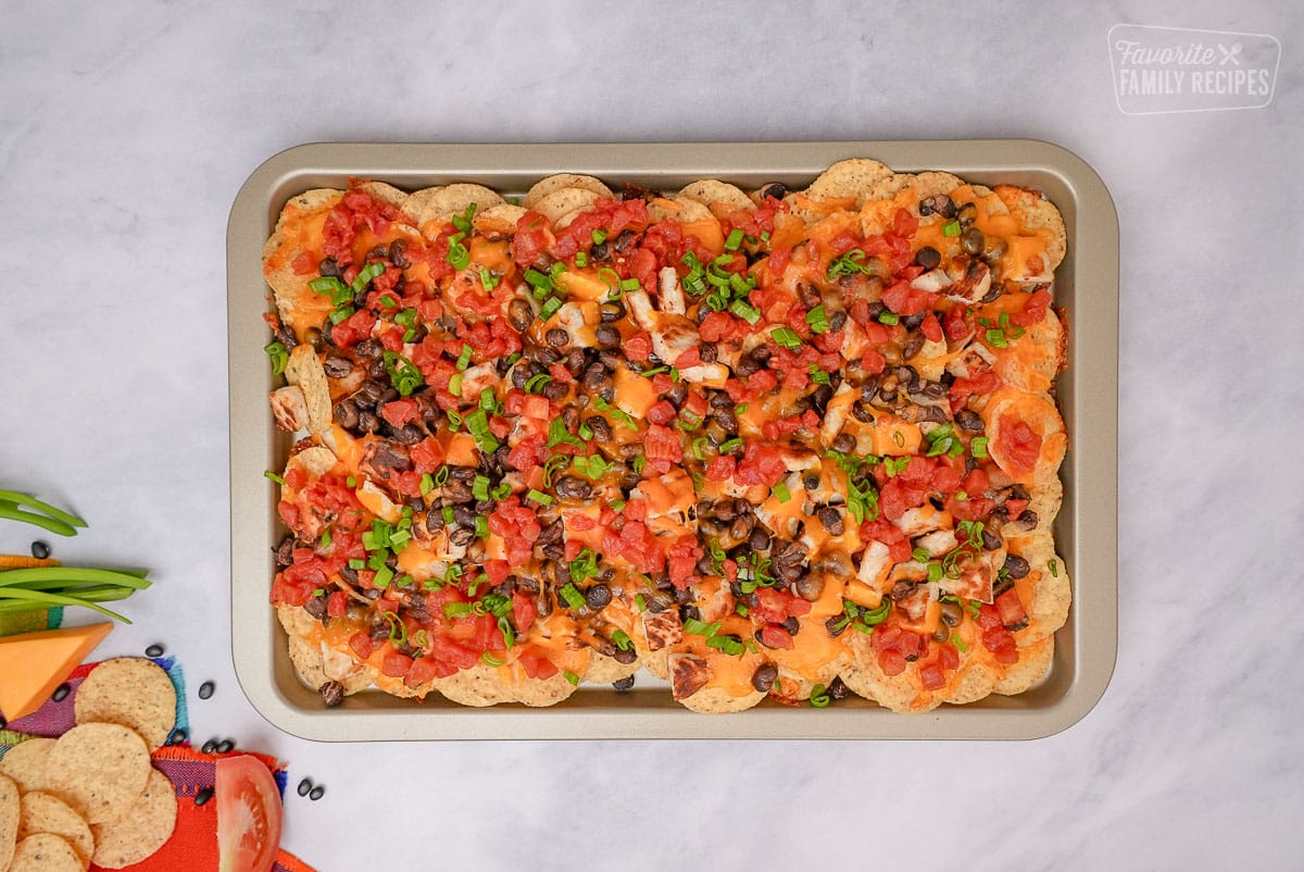 Oven Nachos on a sheet pan with all the toppings