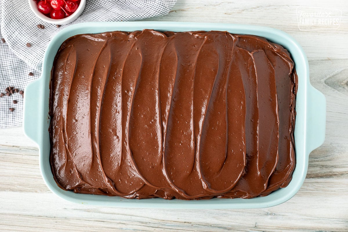 Spread pudding frosting on Chocolate Cherry Cake.