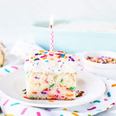 Birthday Candle on top of a slice of Funfetti Cake.