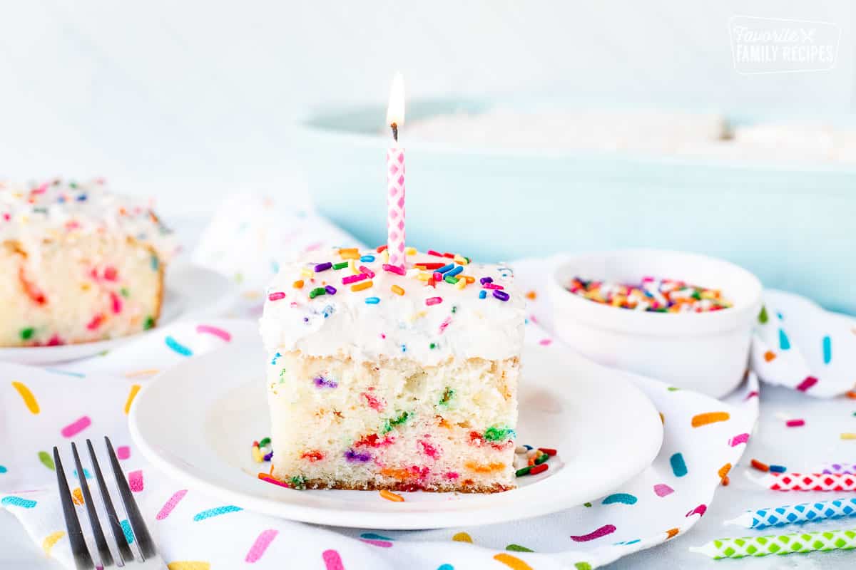 Birthday Candle on top of a slice of Funfetti Cake.