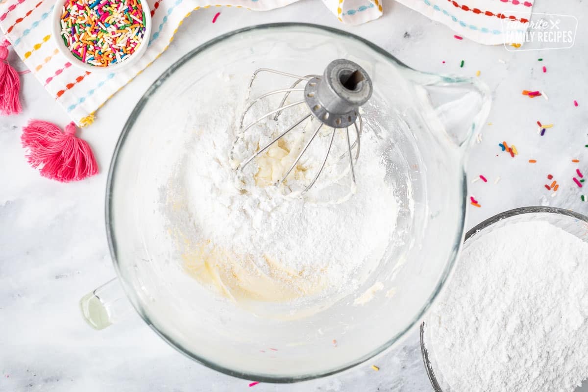 Mixing bowl with butter and powdered sugar with whisk attachment.