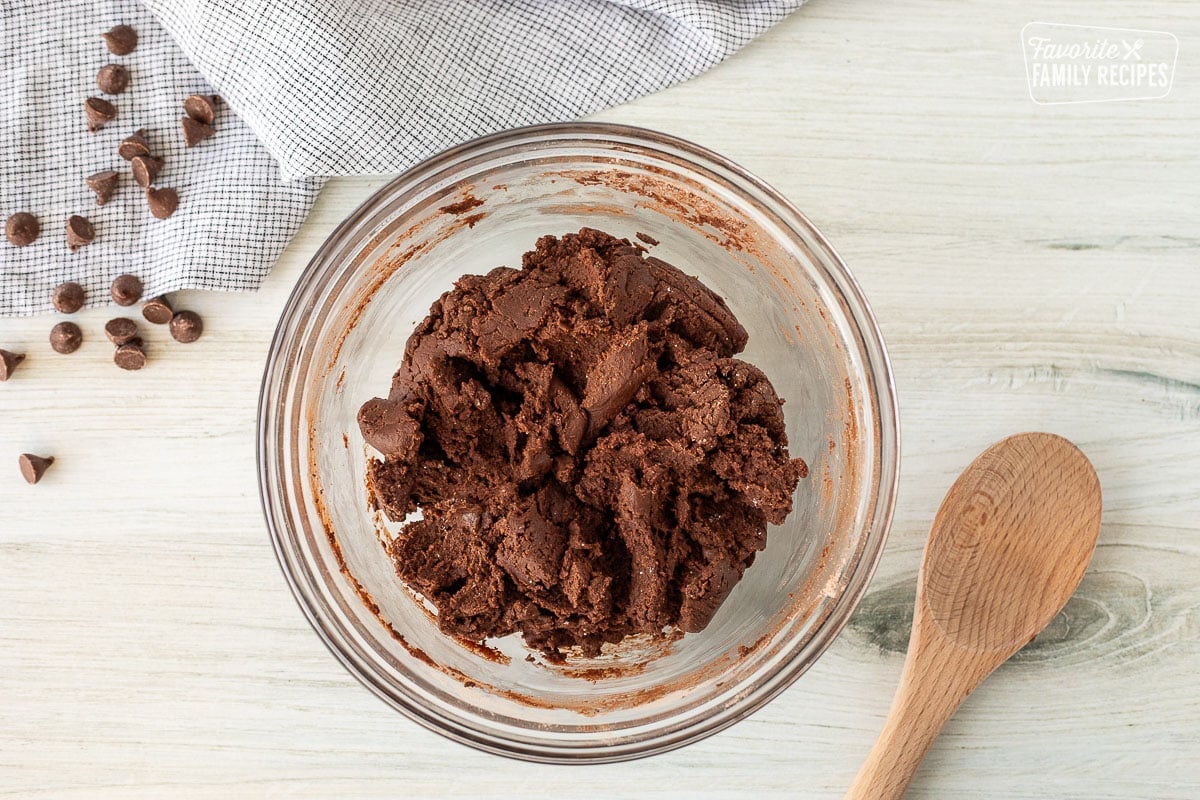 Mixing bowl with cake mixture. Wooden spoon on the side.