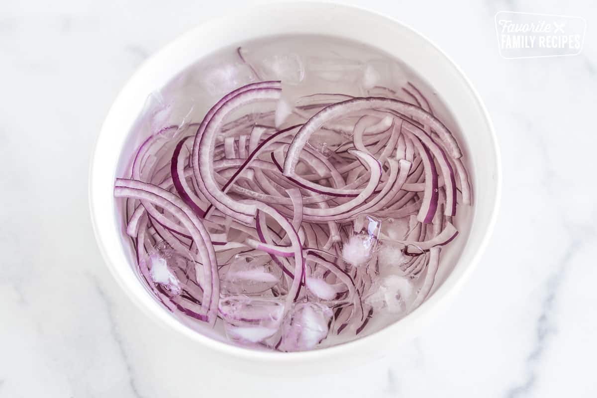red onions in a bowl of ice water