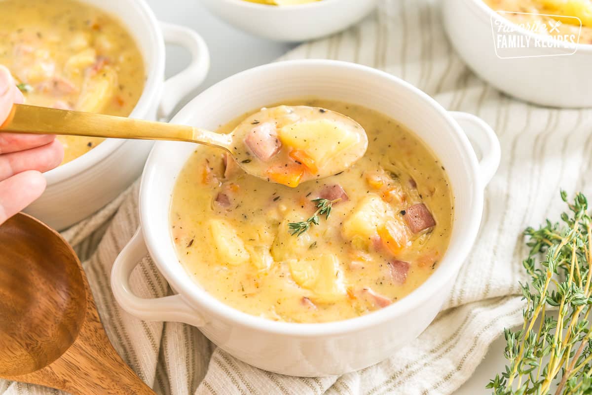 A spoonful of ham and potato soup