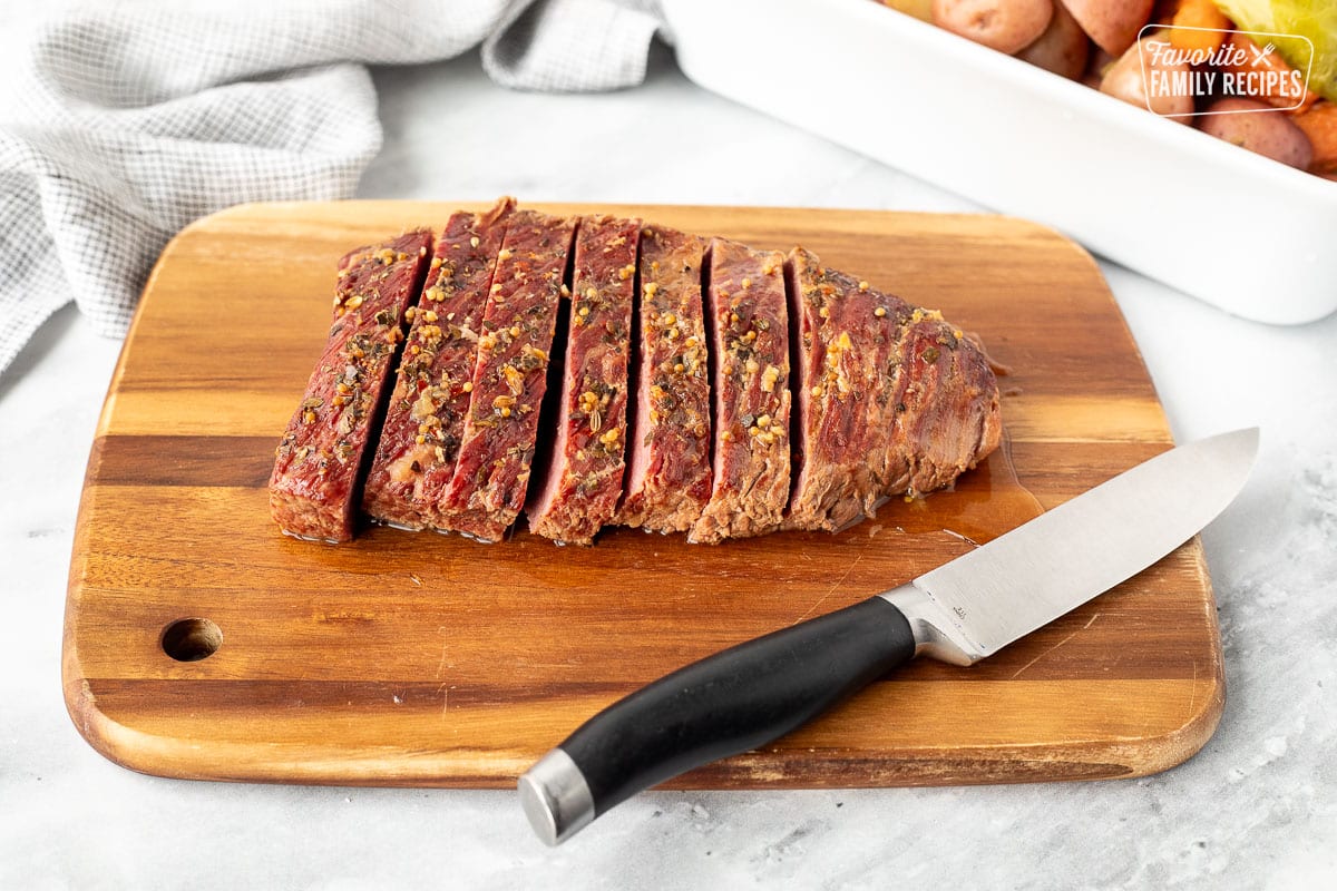 Sliced corned beef brisket cut on a board.