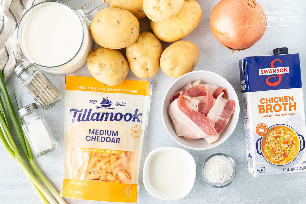 Ingredients to make Instant Pot Loaded Potato Soup including chicken broth, onion, potatoes, cheddar cheese, milk, cream, corn starch, salt, pepper, bacon and green onions.