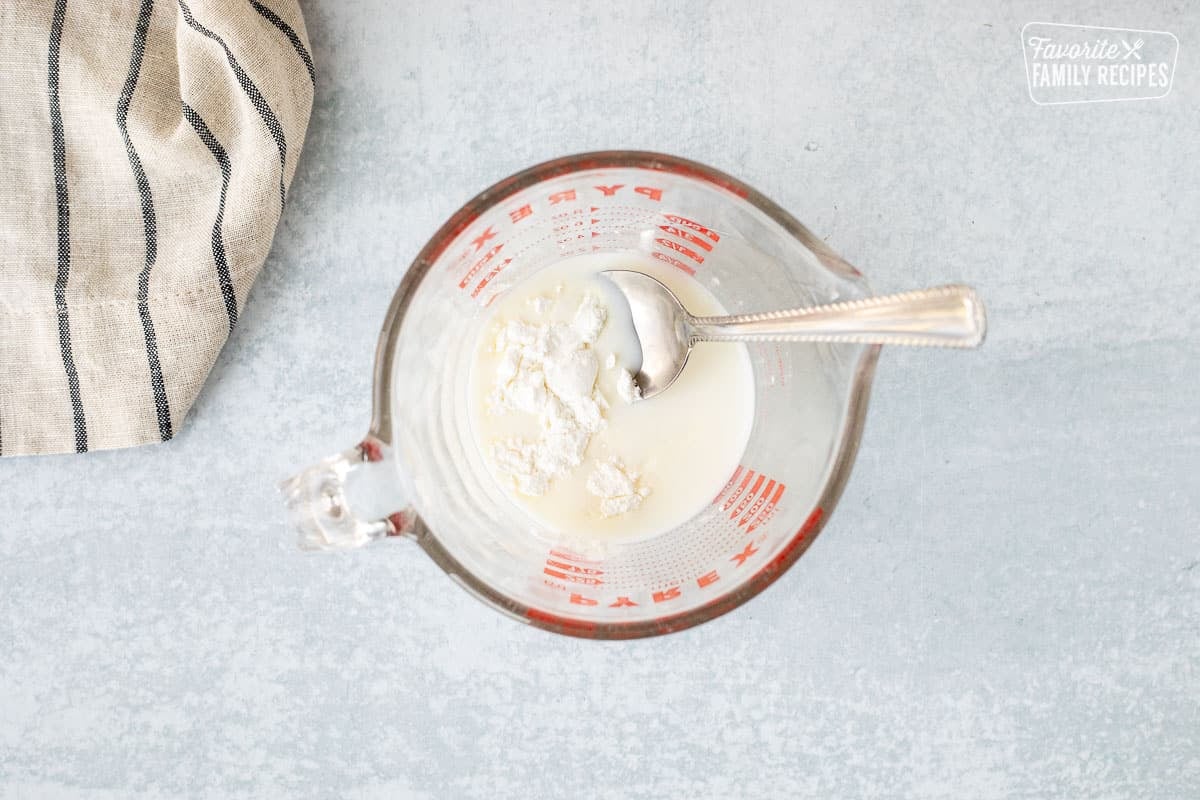 Mixing bowl with milk and corn starch.