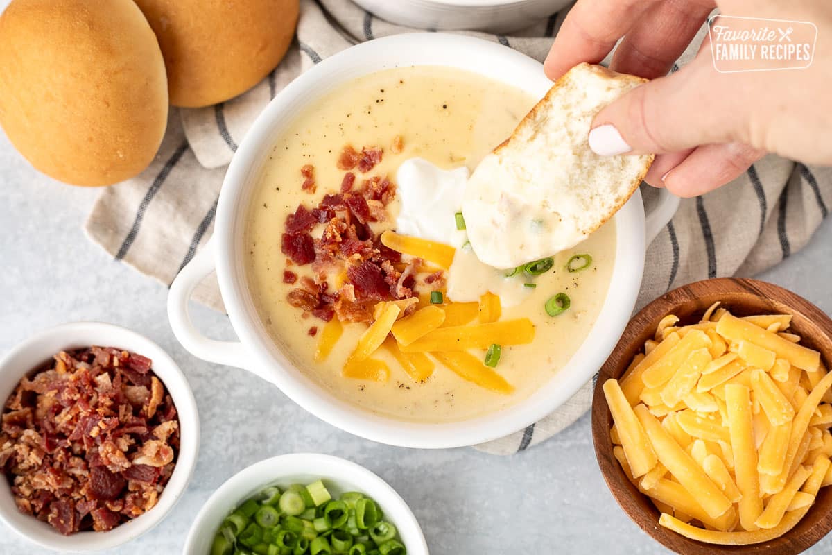 Dipping a roll in Instant Pot Loaded Potato Soup.