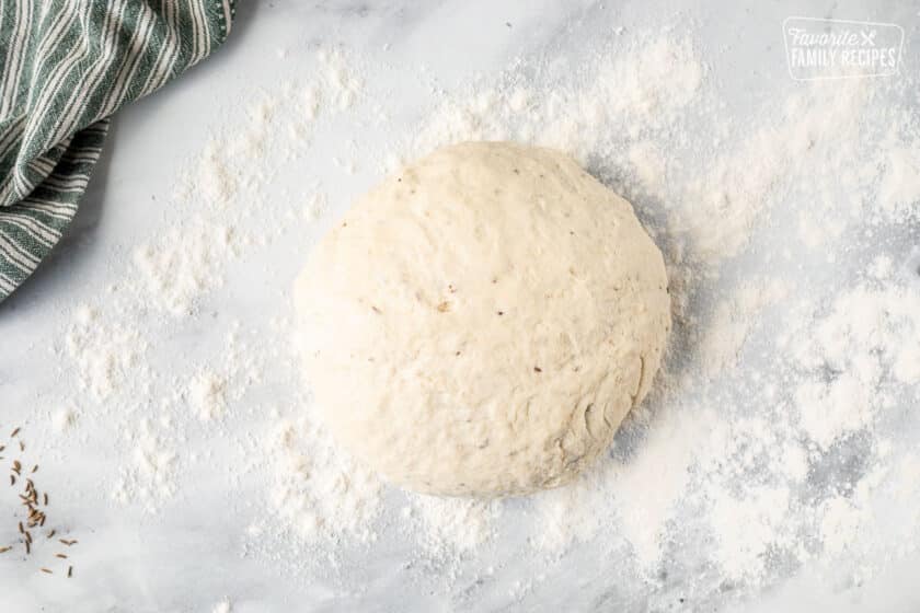 Ball of Irish Soda Bread over a flour surface.