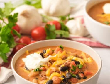 Italian sausage chili in a white bowl.