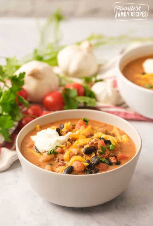 Italian sausage chili in a white bowl.