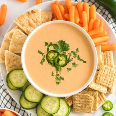 A bowl of Jalapeno Dip with crackers and veggies