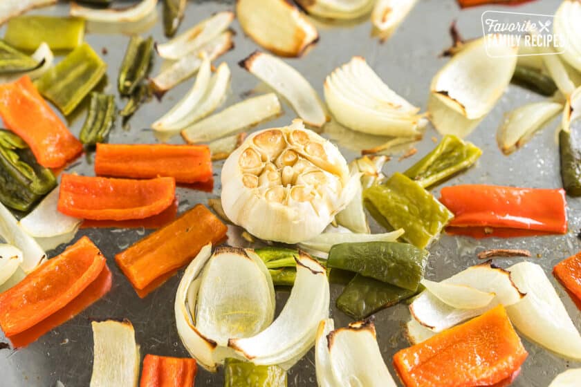 roasted garlic, onions and peppers on a sheet pan