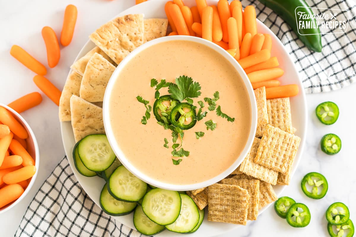 A bowl of Jalapeno Dip with crackers and veggies