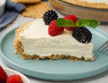 Cheesecake on a blue plate with berries