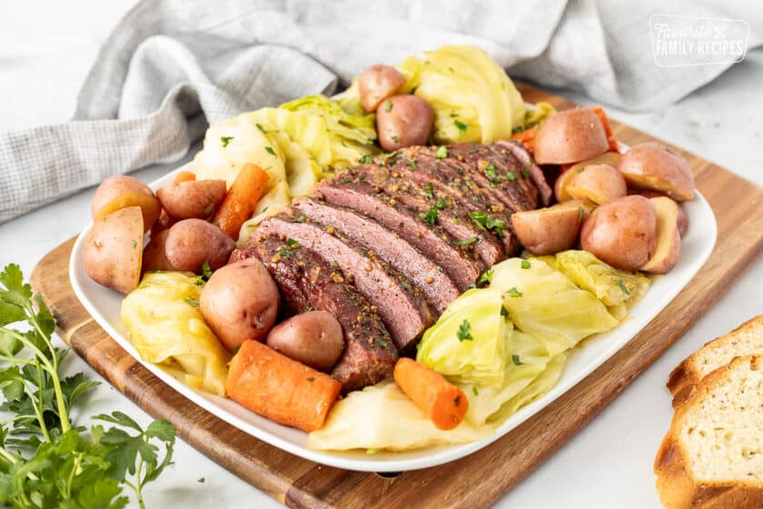 Instant Pot Corned Beef and Cabbage on a platter with carrots and red potatoes.