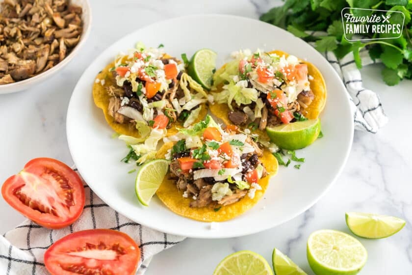 Three shredded pork tostadas on a plate