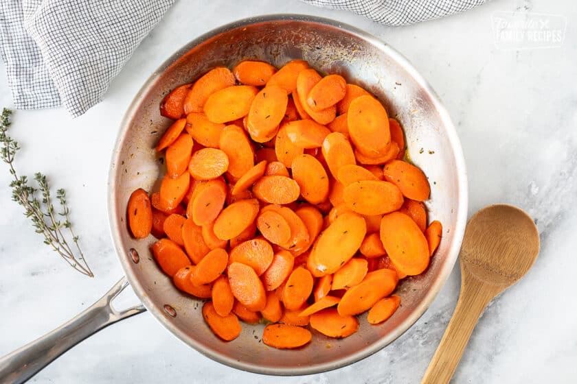 Skillet with Glazed Carrots and wooden spoon.