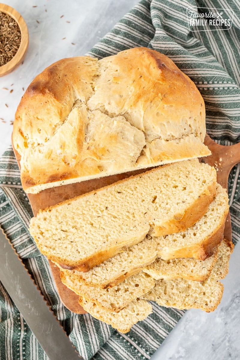 Irish Soda Bread is an authentic and tasty side to accompany your St. Patrick's Day meal. No yeast, no waiting for it to rise, super easy to make! Sliced loaf of Irish Soda Bread and a bread knife.