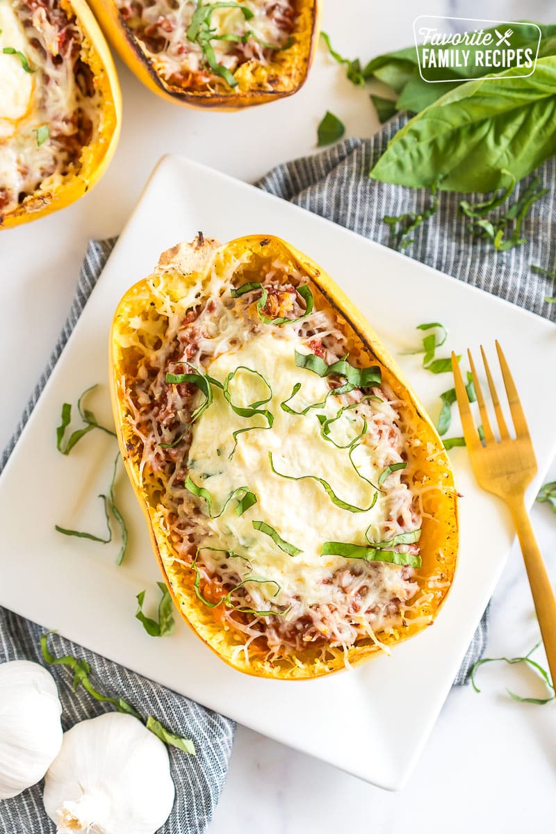 A Spaghetti Squash Lasagna on a plate topped with fresh basil.