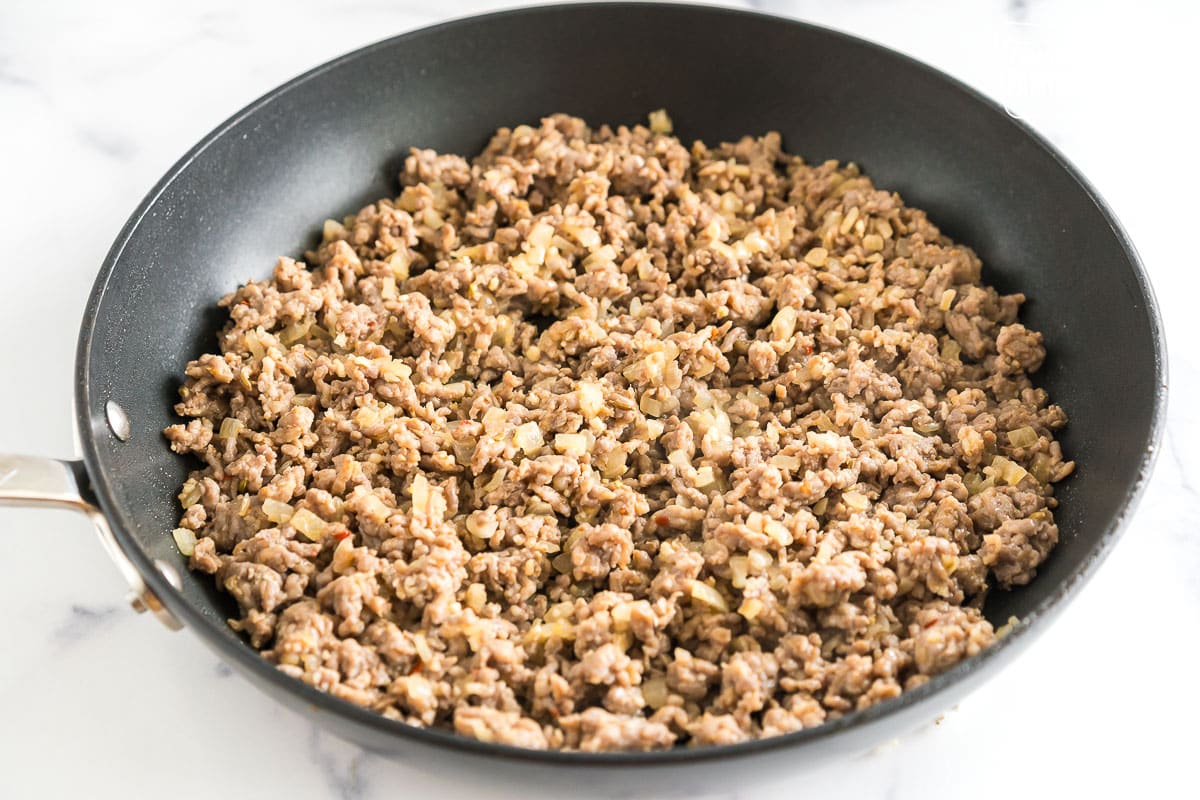 crumbled Italian sausage cooked in a skillet